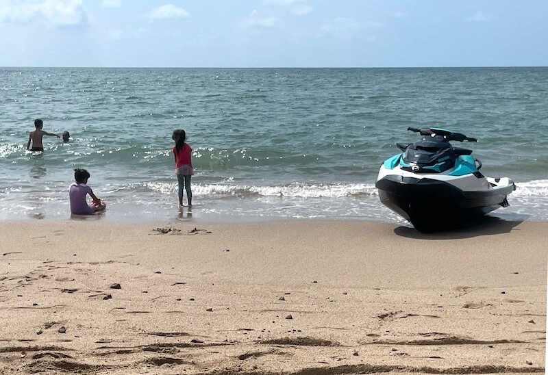 kids playing in the ocean in Puerto Vallarta next to a jetski