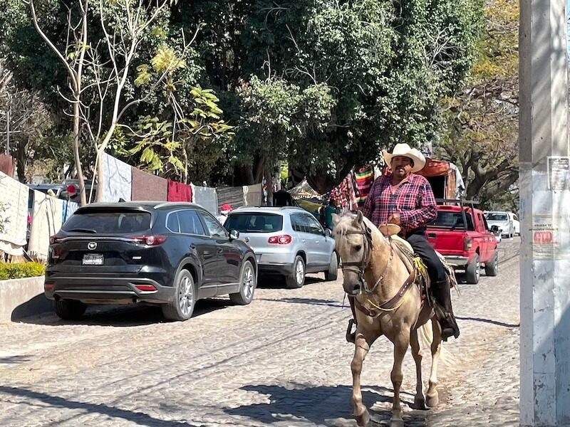 cowboy riding a horse in a Pueblo Magico in Jalisco