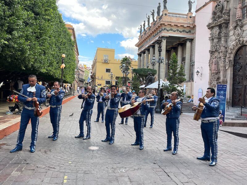 group of mariachis in blue suits playing in Guanajuato
