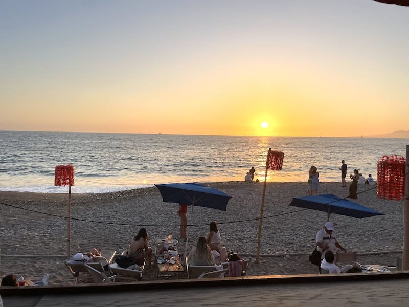 sunset over the tables on the beach at El Solar Beach Club PV