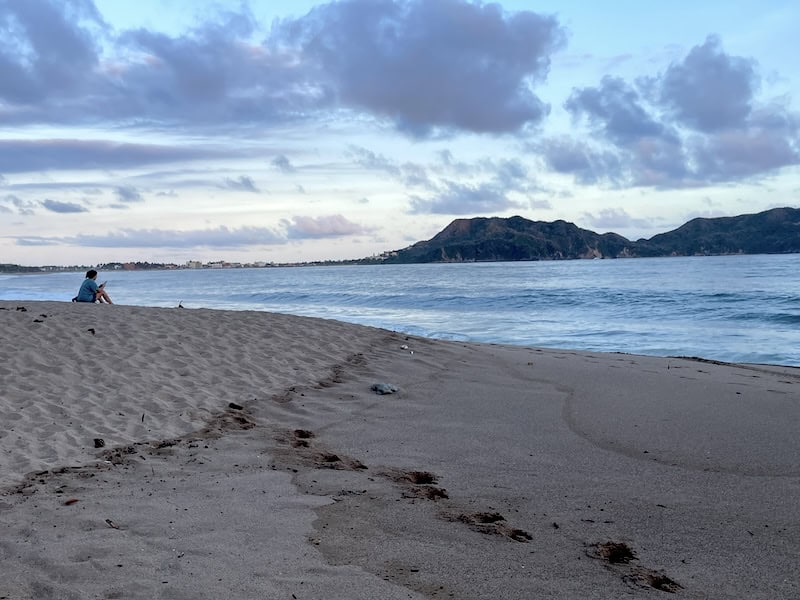 woman sitting on the beach in Melaque