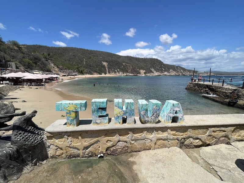 colorful Tehua sign in front of the beach