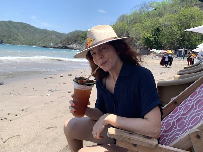 me in a hat drinking a michelada in Melaque, Mexico