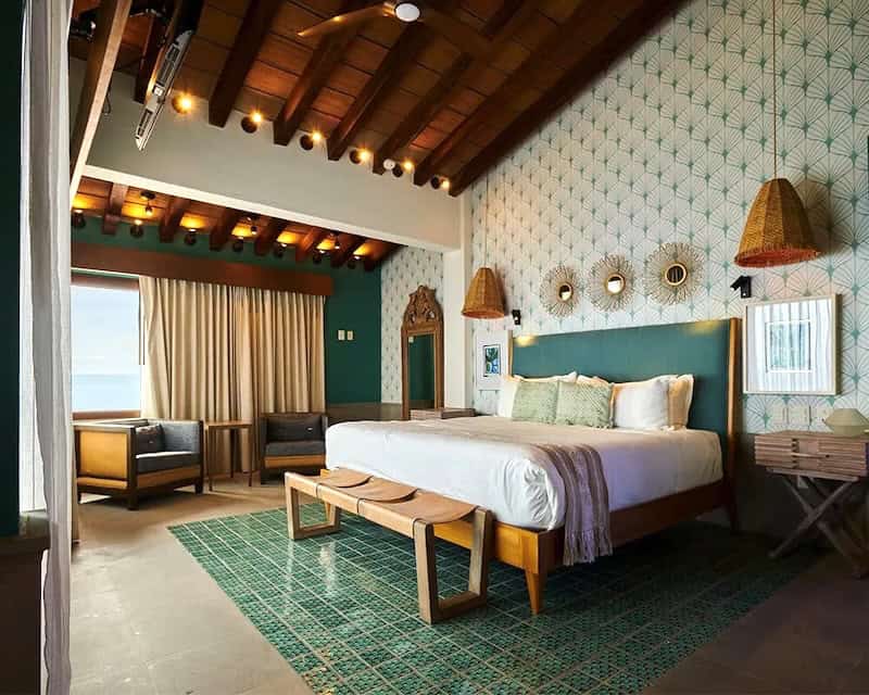 luxury room at Hotel Patio Azul with green tiles and  colorful details to match. 