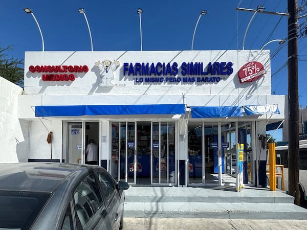 Los Cabos, Baja California Sur, Mexico. Dec 4, 2024. A bright blue and white storefront with a sign advertising Farmacias Similares and a cartoon doctor logo. The slogan reads Same thing but cheaper