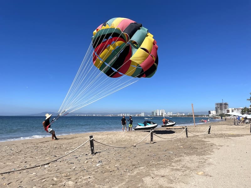 parasailer getting ready to fly at Playa Camarones Beach in Puerto Vallarta