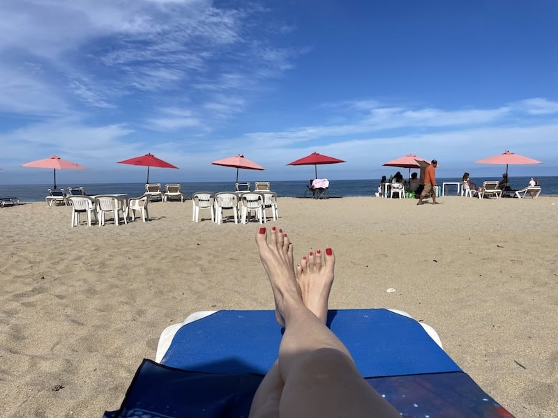 my feet resting on San Pancho beach at Puerto Vallarta, Mexico