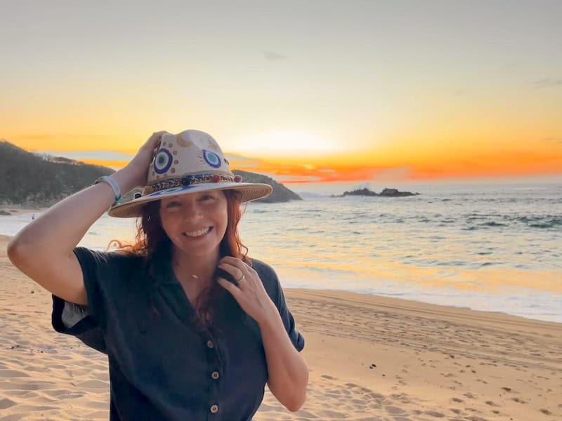 girl with a hat on Mayto beach at sunset