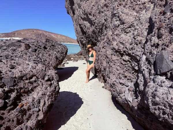 Me between lunar looking rocks near a beach in La Paz, Mexico